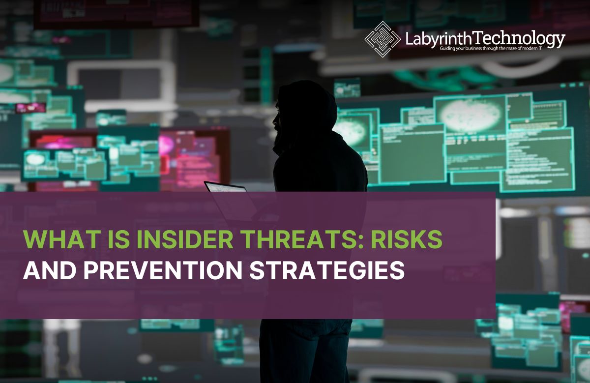 A man in a black hoodie surrounded by red and green computer screens displaying various coding tropes. The Labyrinth Technology logo is in the top right. The text reads "What is Insider Threats: Risks and Prevention Strategies"