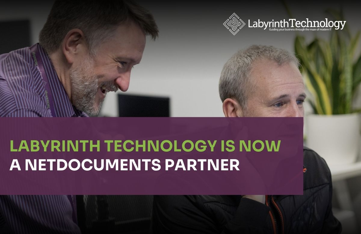 Two men talking and laughing. The text in the bottom left reads"Labyrinth Technology is Now a NetDocuments Partner." The Labyrinth Technology logo is in the top right.