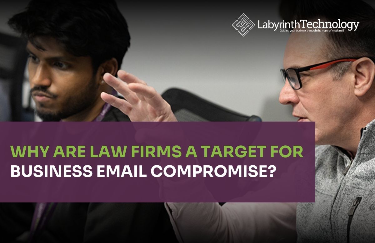 Two men sitting in front of monitors at work. One is explaining something to the other. The text in the bottom left reads "Why Are Law Firms a Target for Business Email Compromise?" The Labyrinth Technology logo is in the top right.
