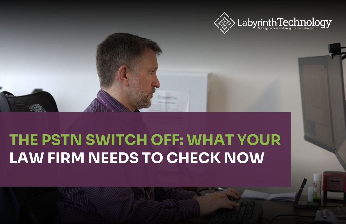 A man concentrating while working infront of two desktop monitors. The text in the bottom left reads"The PSTN Switch Off: What Your Law Firm Needs to Check Now" The Labyrinth Technology logo is in the top right.
