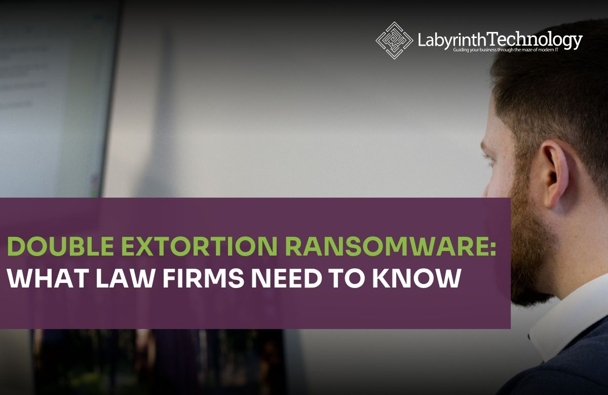 A man in the foreground working on his laptop and 2 large monitors. The Labyrinth Technology logo is in the top right corner. The text in bottom left says "Double Extortion Ransomware: What Law Firms Need to Know"