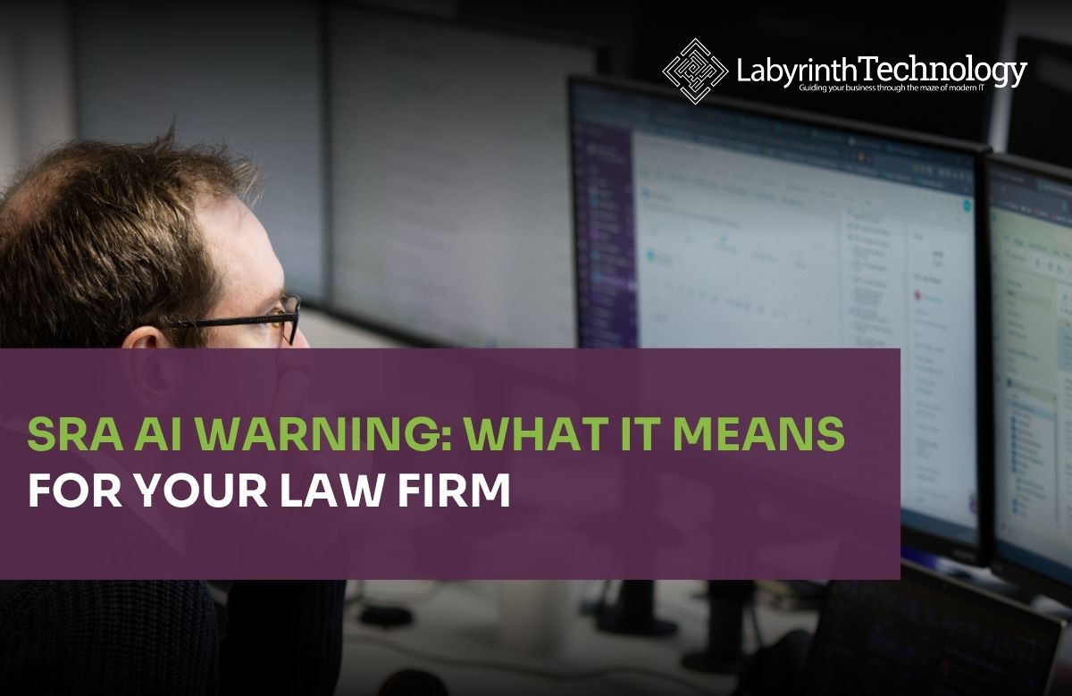 A man in the foreground working on his laptop and 2 large monitors. The Labyrinth Technology logo is in the top right corner. The text in bottom left says "SRA AI Warning: What It Means For Your Law Firm"